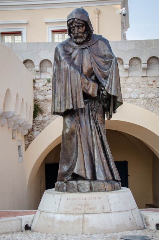 A statue of Grimaldi disguised as a monk with a sword under his frock before the Prince's Palace of Monaco.
